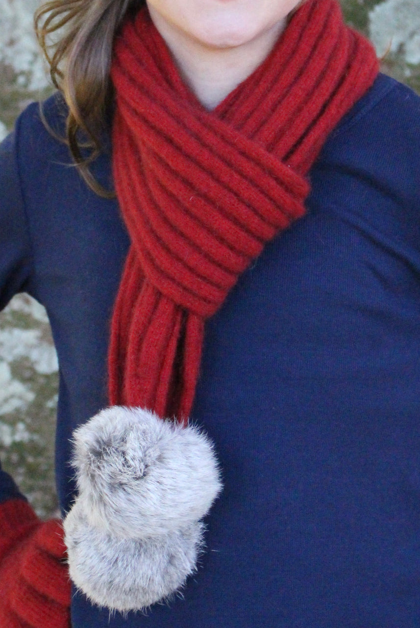 Girl wearing red colour scarf.
