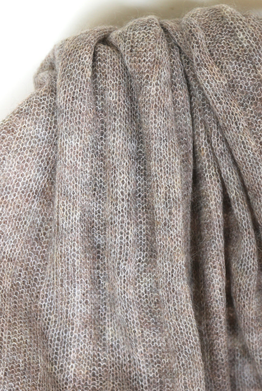 Close up of fawn-coloured Knight Mohair Throw draped over chair.