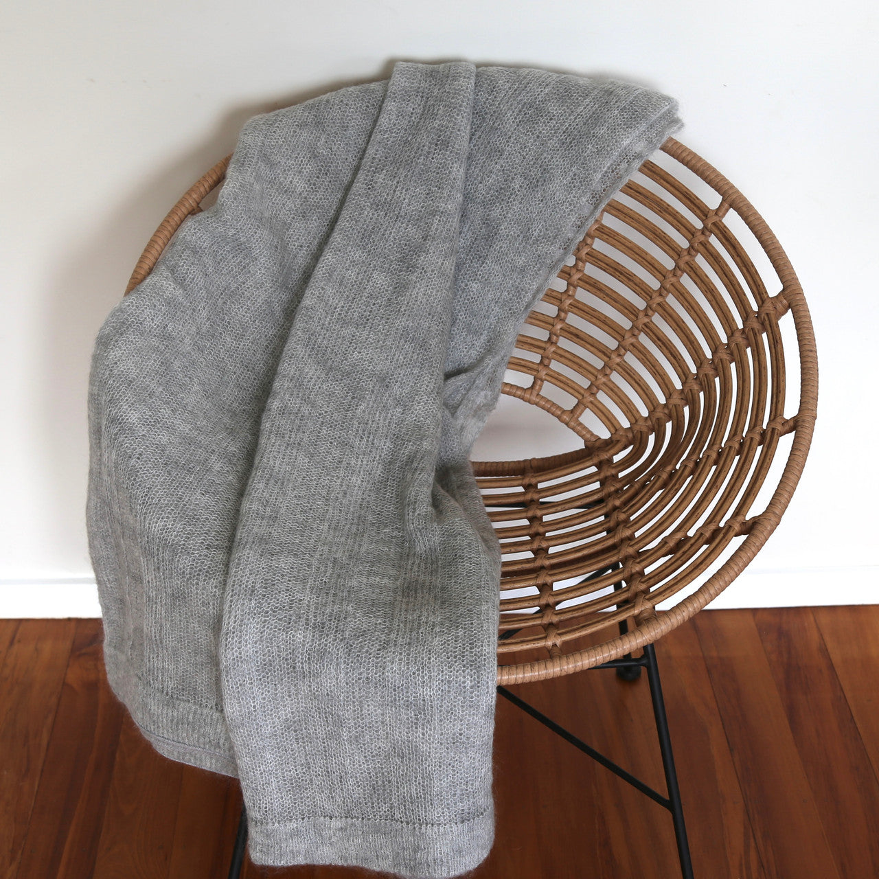 Silver-coloured Knight Mohair Throw draped over wooden chair.