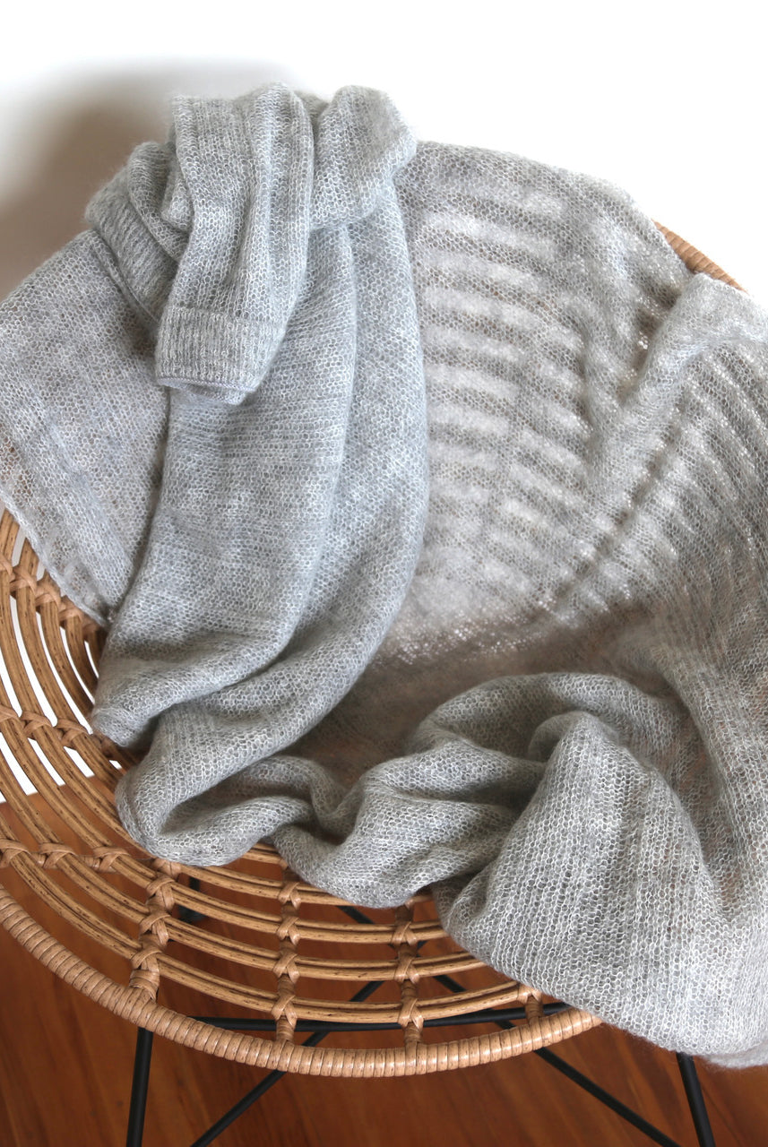 Silver-coloured Knight Mohair Throw draped over chair.