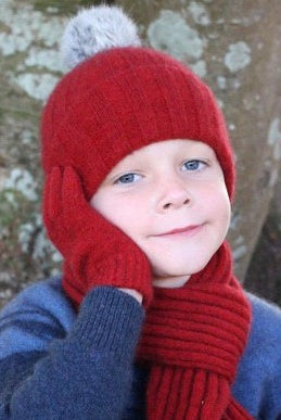 Child wearing beanie, scarf and gloves. Colour Red