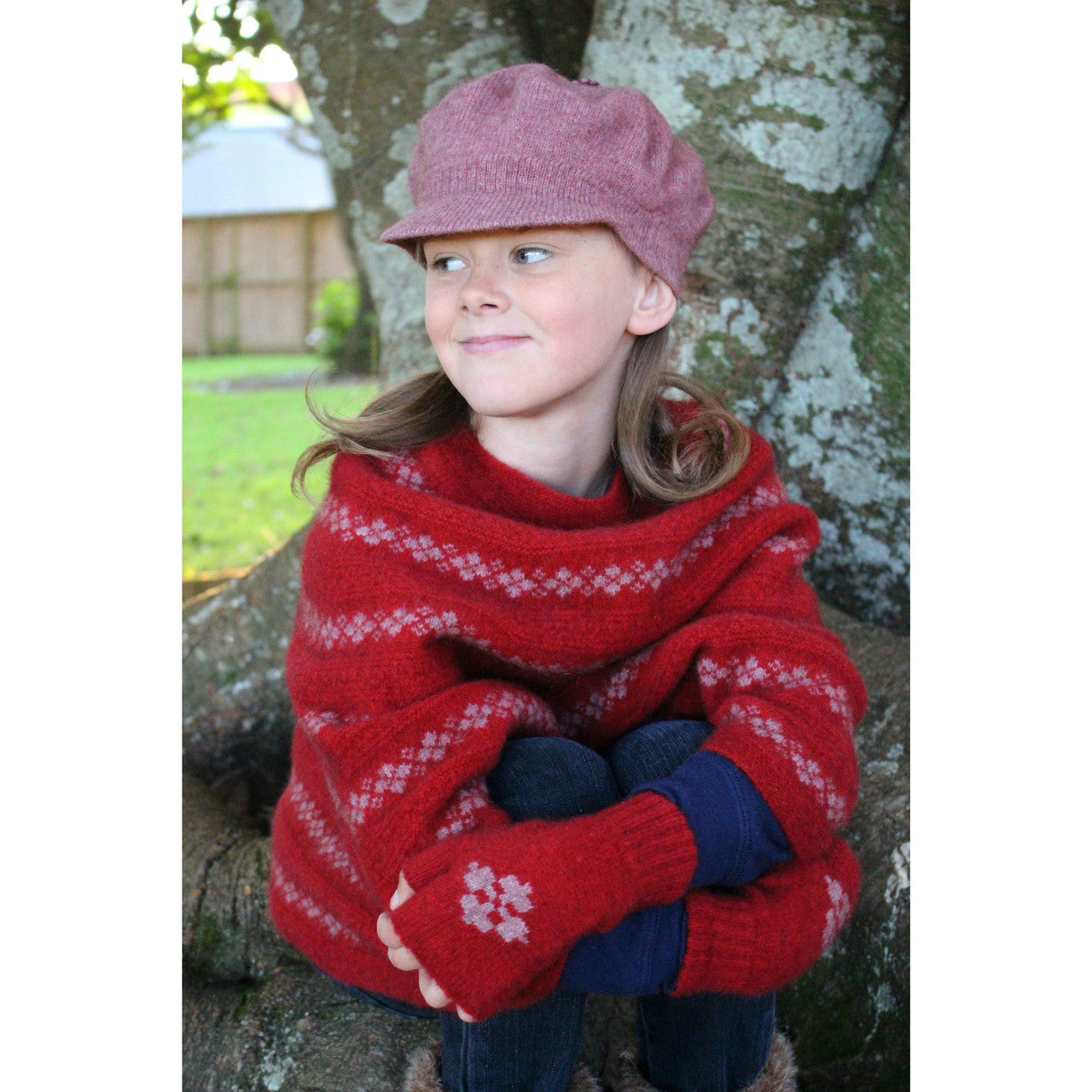 Girl looking to the left wearing pink Gatsby hat.