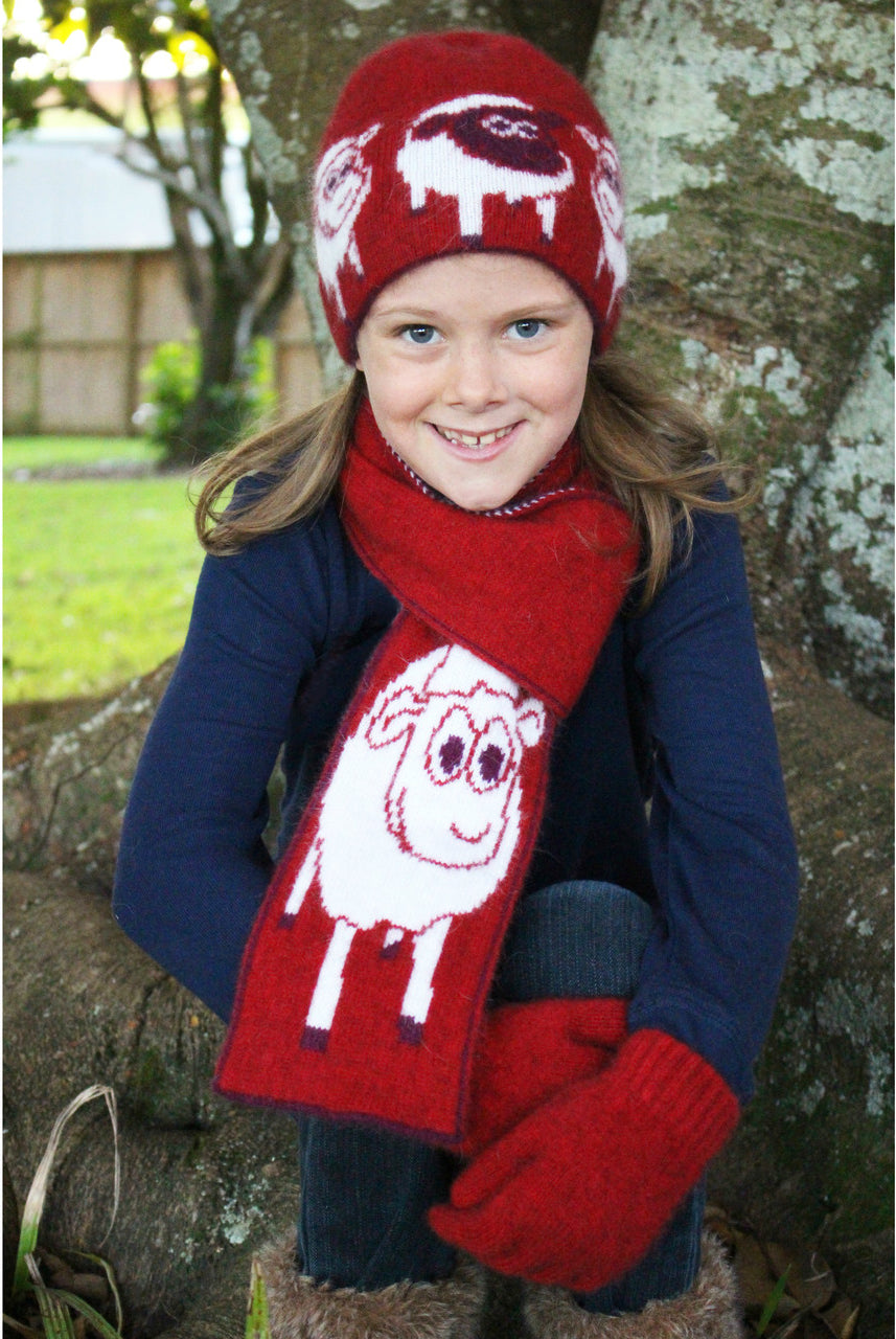 Girl sitting wearing scarf in colour red.