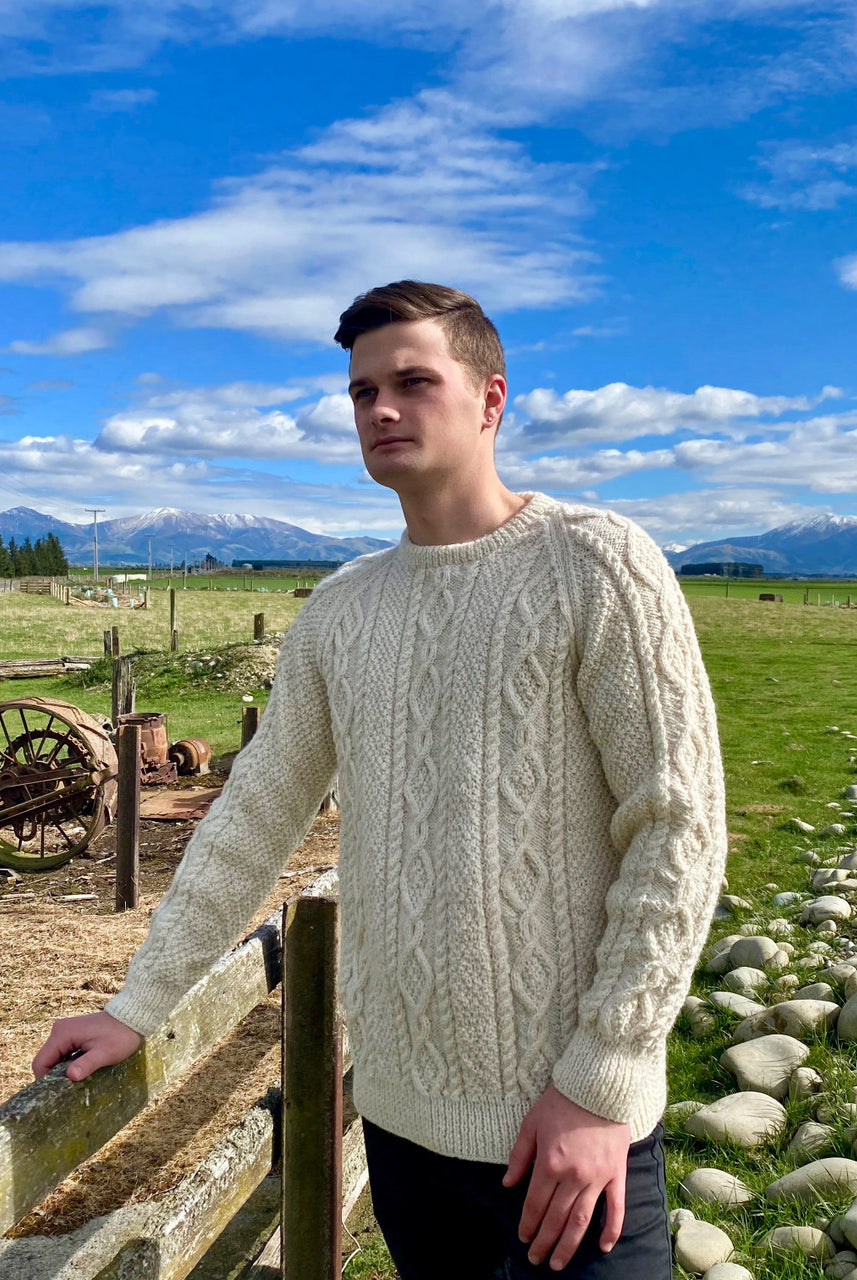Man wearing Lesley Unisex Aran Wool sweater in the colour Cream.