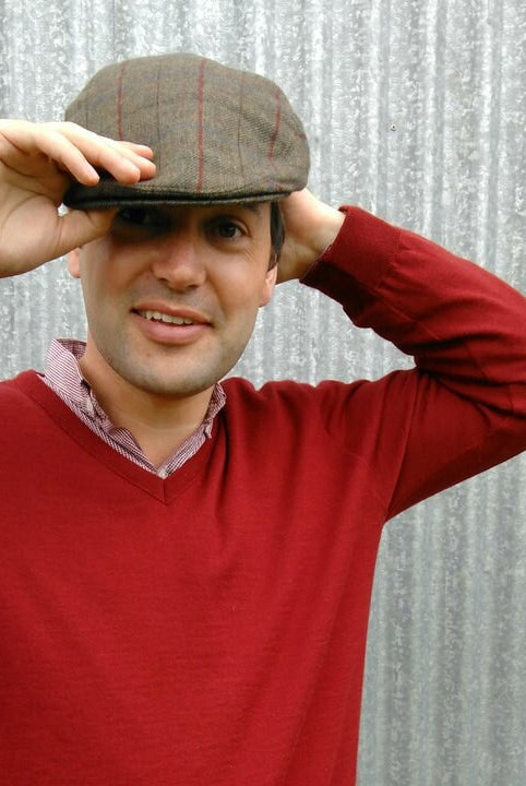 Man wearing olive coloured Bingley Check Lambswool Tweed Cheesecutter hat.
