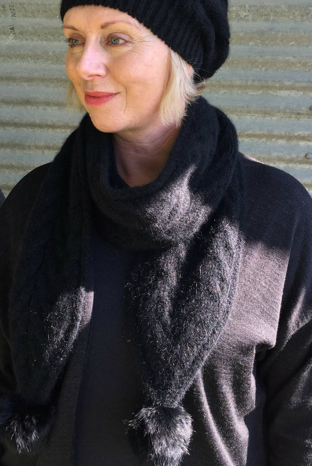 Black-Woman wearing black beanie and black outfit.