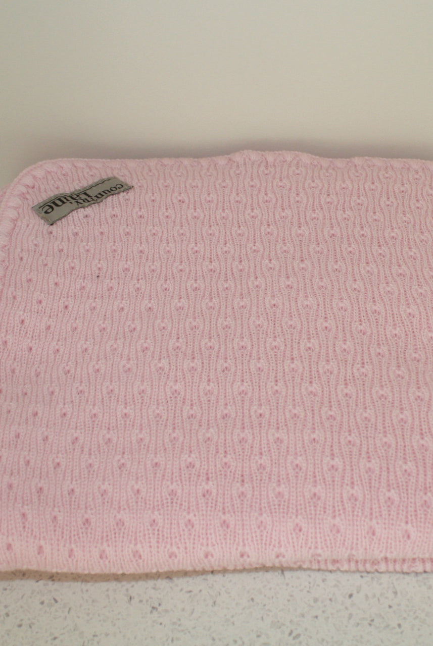 Pink coloured baby blanket.