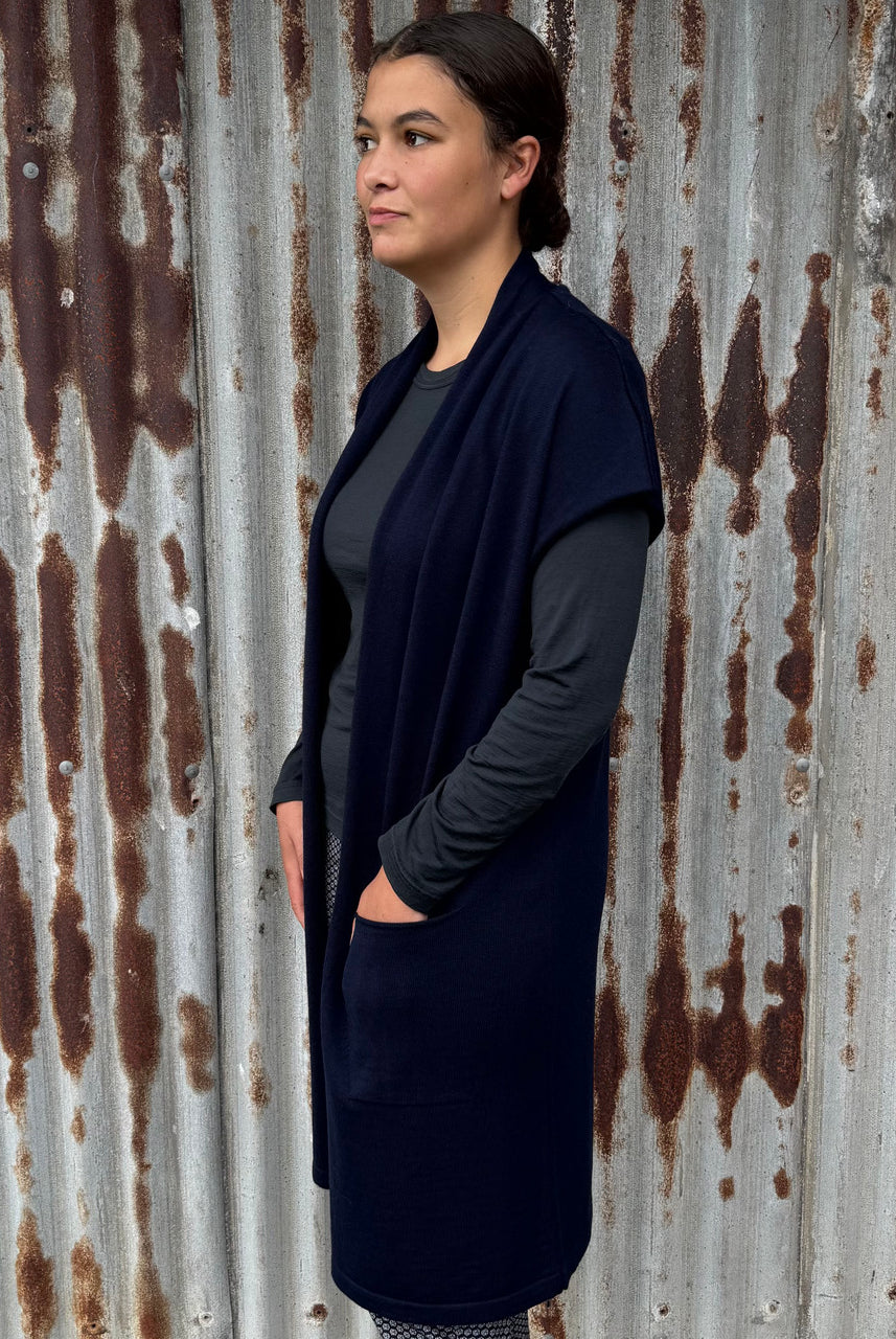 Woman wearing Country Laine - Merino Longline Cap Sleeve Cardigan (CL069) in the colour Navy