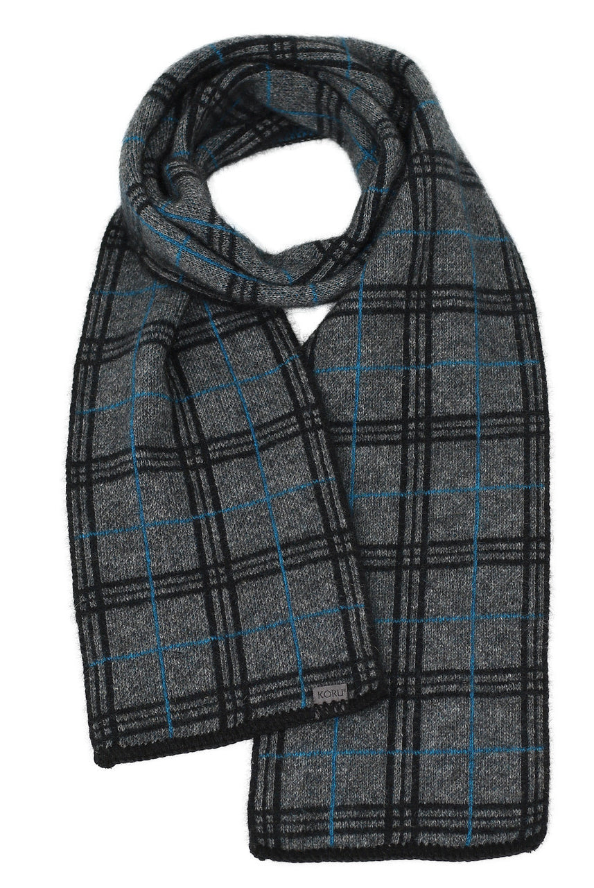 A grey, black, and pacific-coloured Koru merino and possum Tartan Scarf.