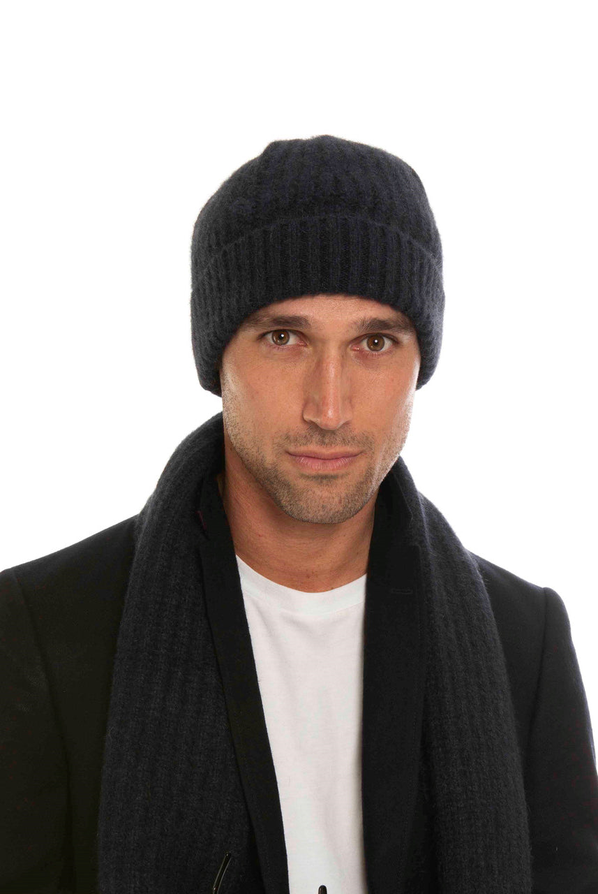 A man wearing an indigo-coloured Koru Merino and Possum Ribbed Scarf and Beanie Set.