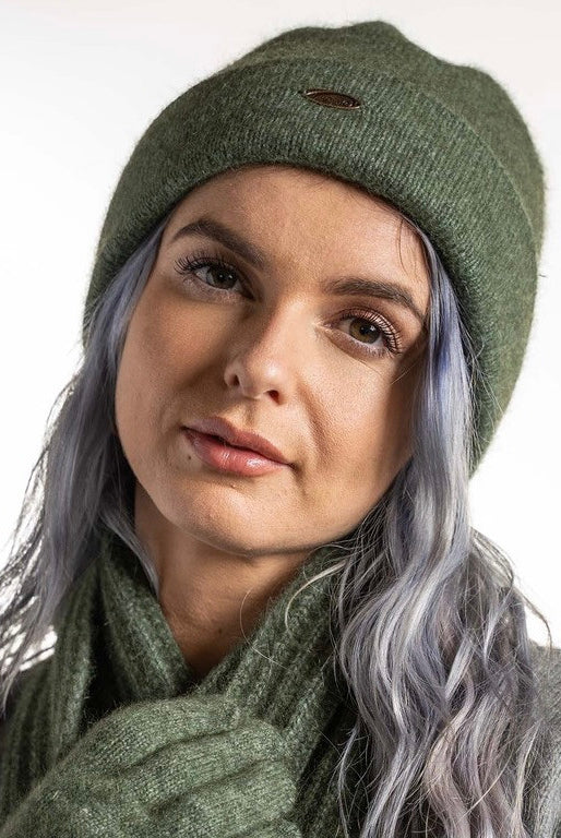 A woman wearing an Moss-coloured Koru Merino and Possum Plain Beanie.