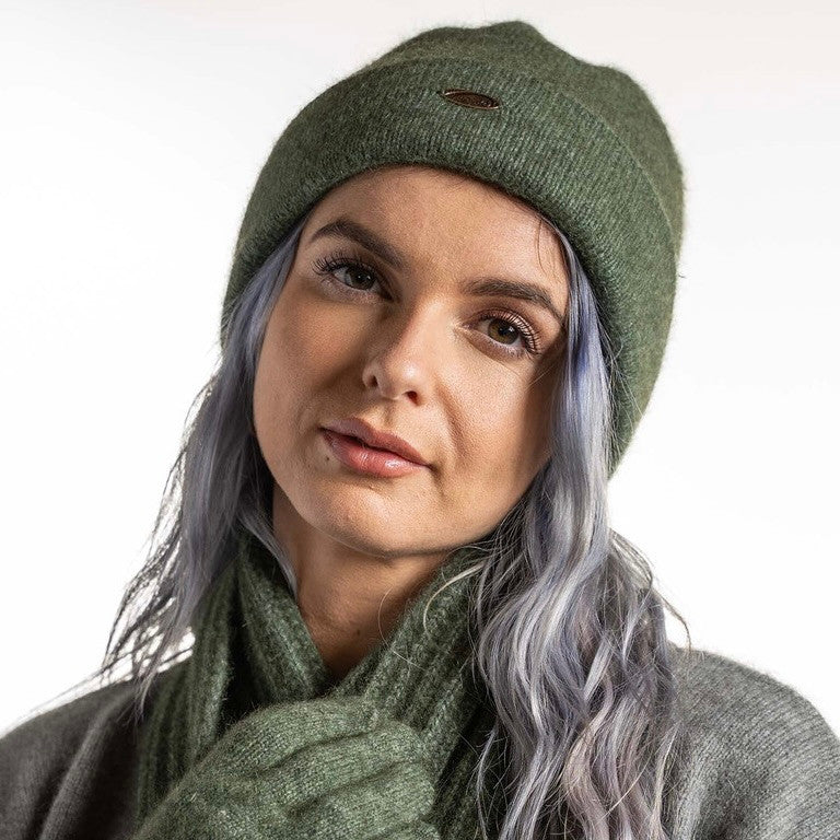 A woman wearing an Moss-coloured Koru Merino and Possum Plain Beanie.