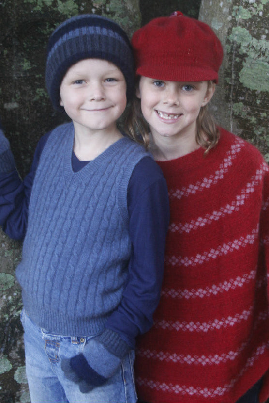 Boy wearing light blue colour vest & standing next to girl wearing red clothes.