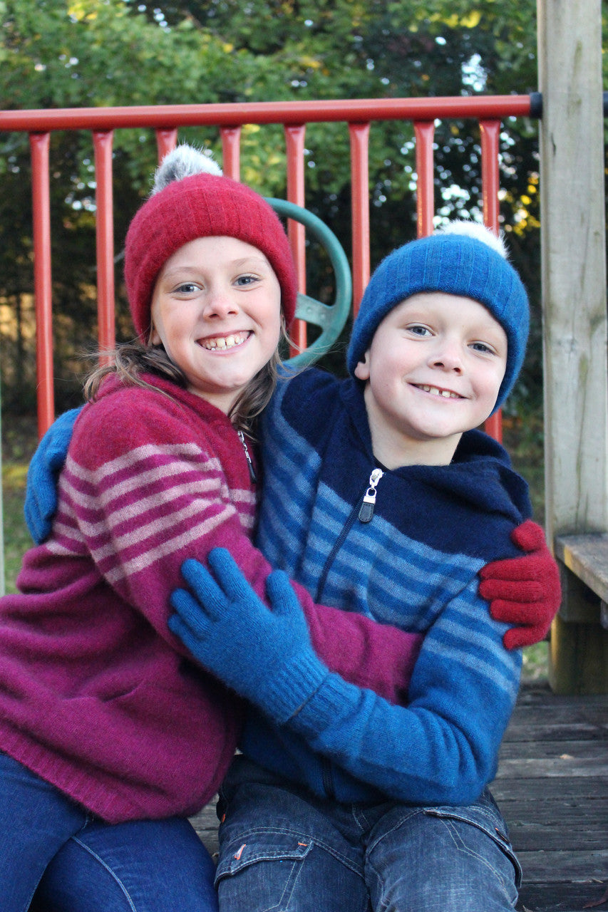 Girl wearing fuchsia colour striped hoodie hugging boy wearing lagoon colour striped hoodie.