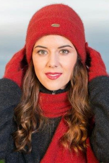 A woman wearing an Red-coloured Koru Merino and Possum Plain Beanie.