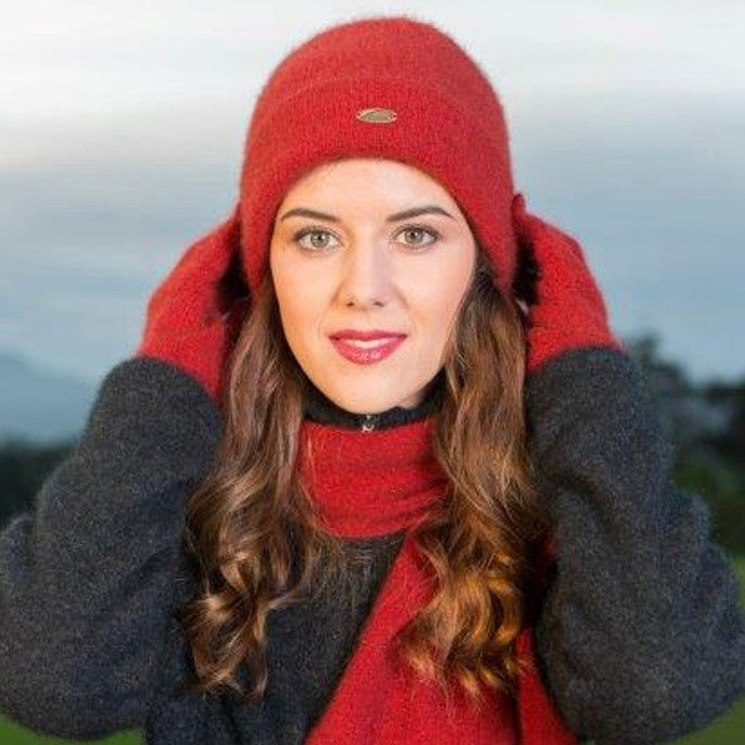 A woman wearing an Red-coloured Koru Merino and Possum Plain Beanie.