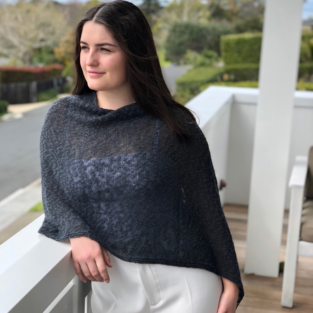 Woman wearing cotton poncho. Colour Iron