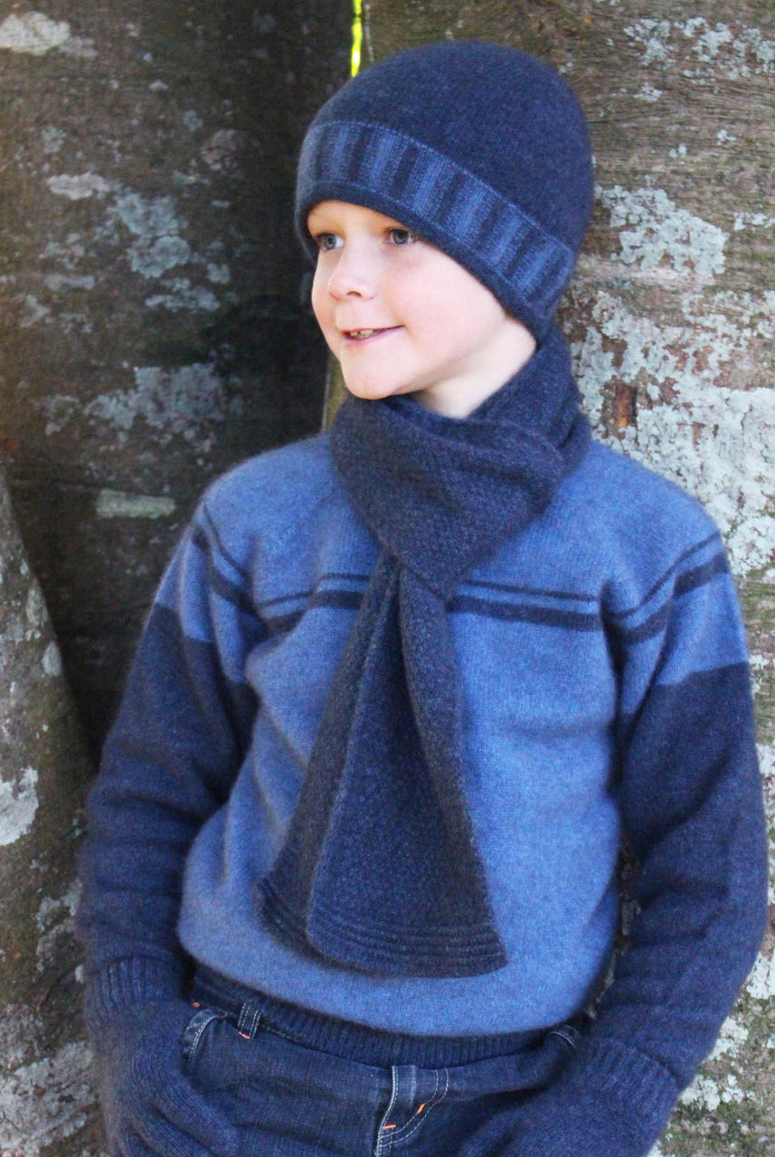Boy facing right wearing Denim colour jumper.