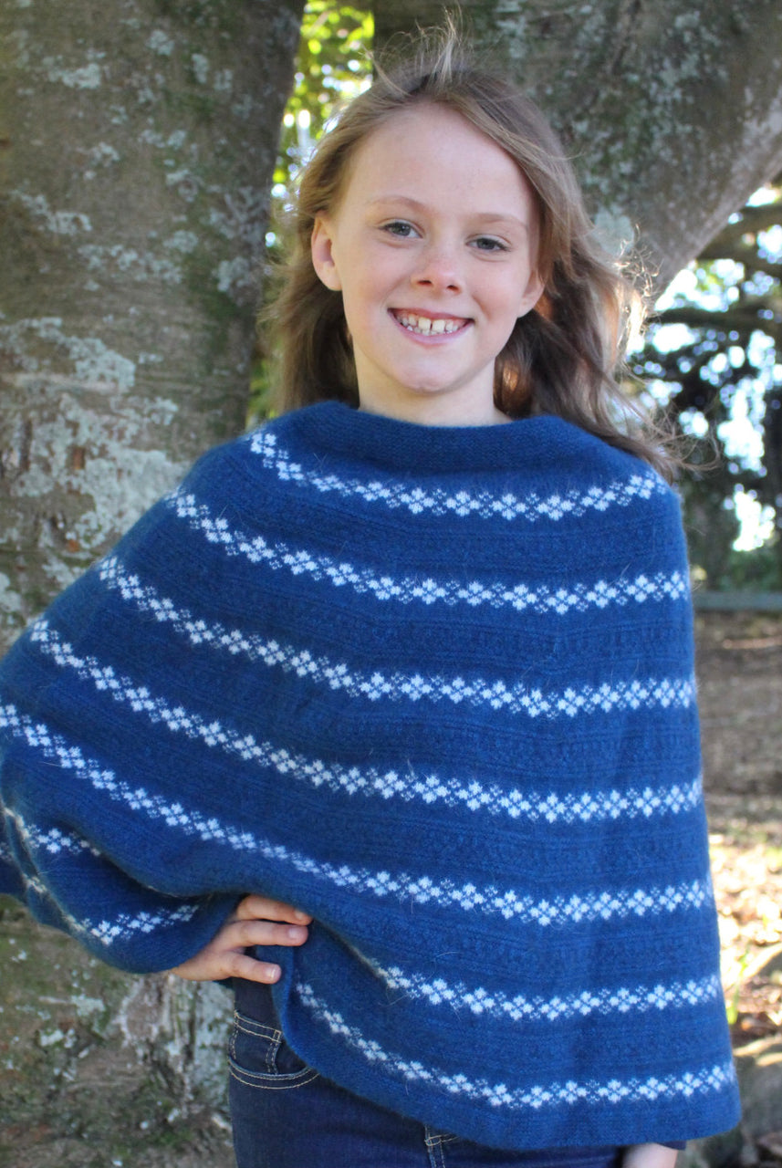 Girl wearing Poncho in colour lagoon.