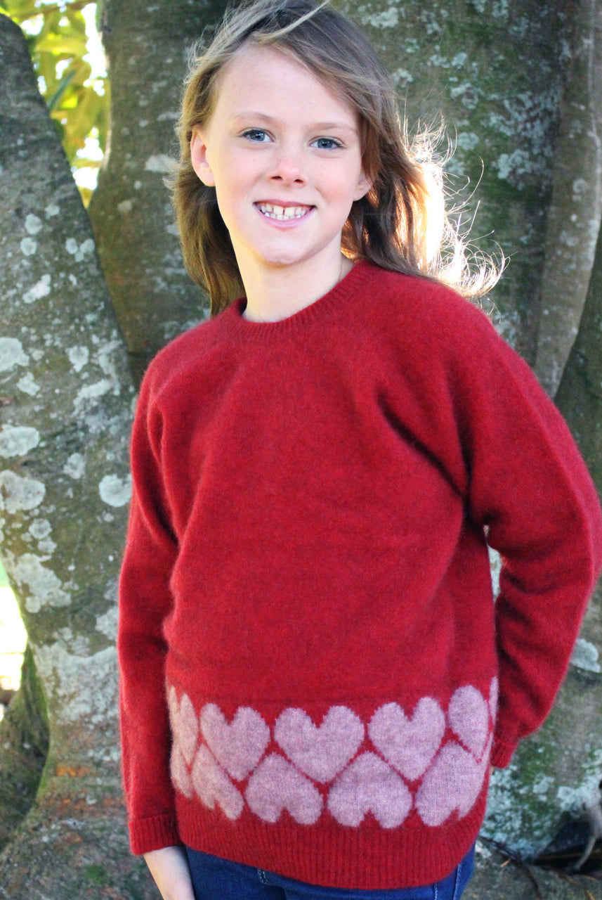 Girl wearing Jumper in colour red.
