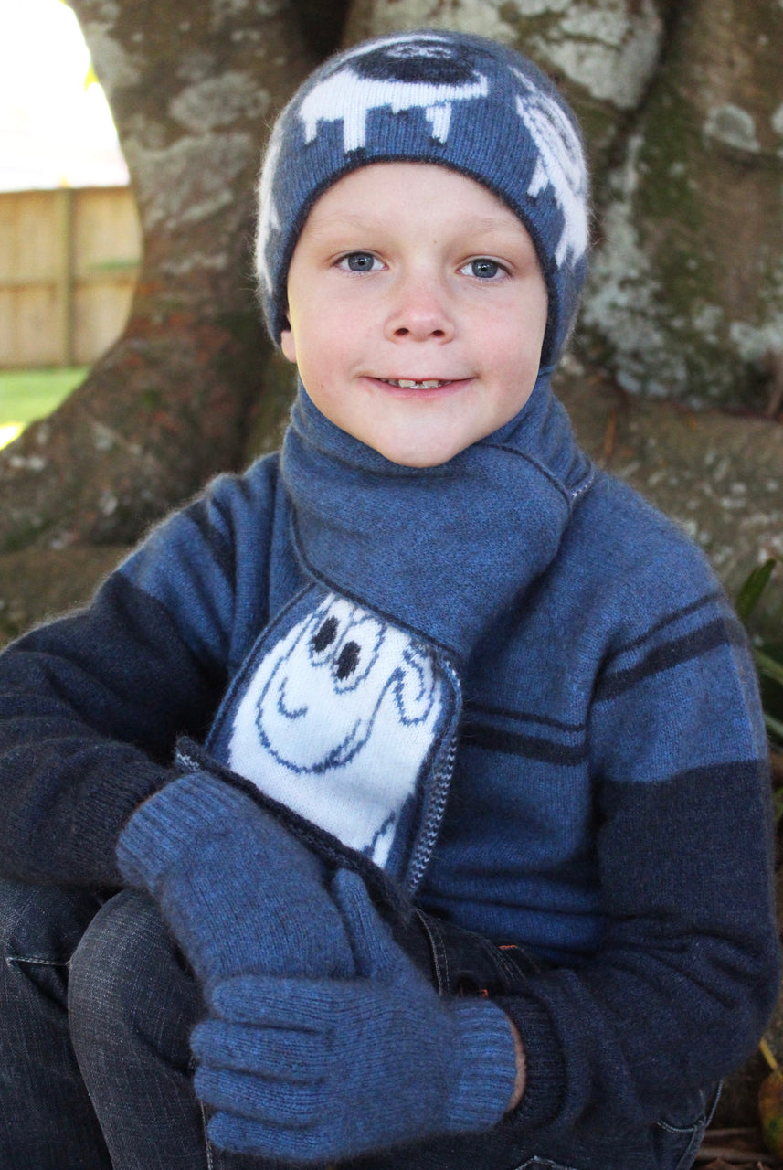 Boy sitting facing forward wearing Beanie in colour blue.