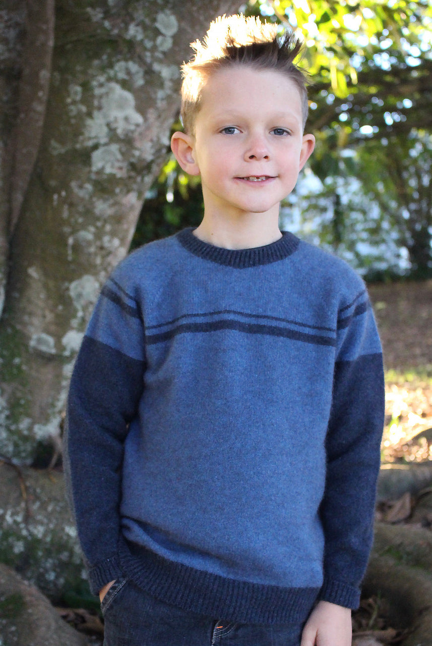 Boy facing straight wearing Denim colour jumper.