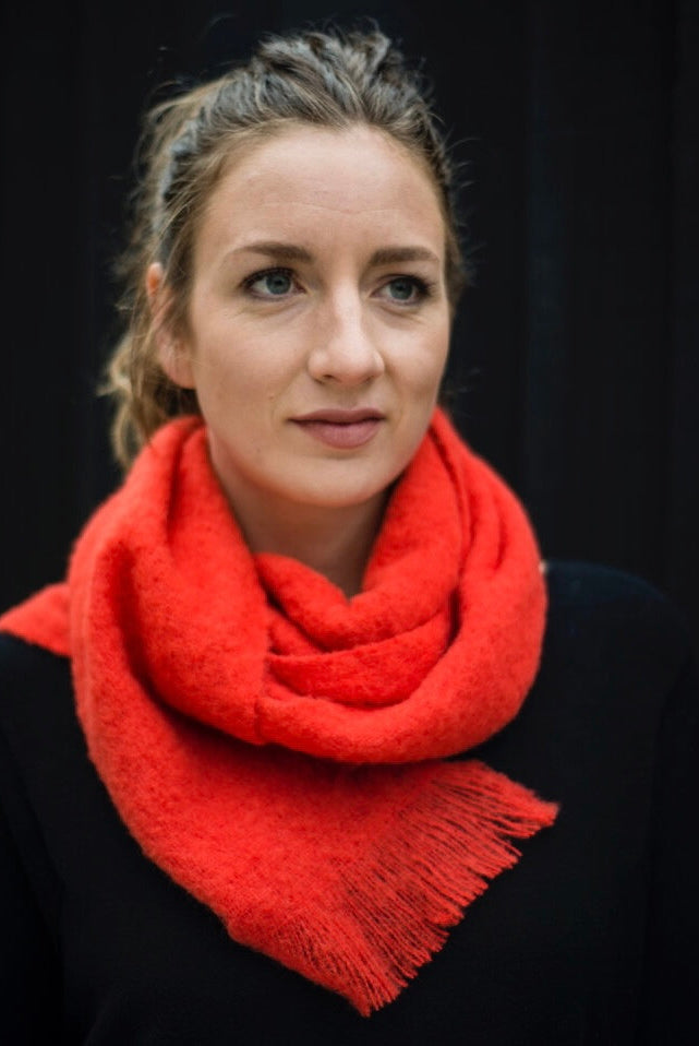 Model wearing Alpaca scarf in colour Hibiscus