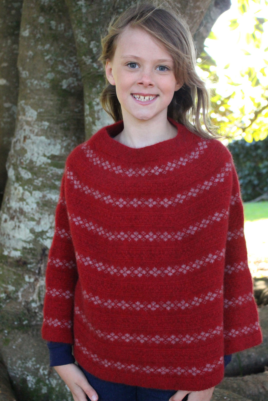 Girl wearing Poncho in colour red.