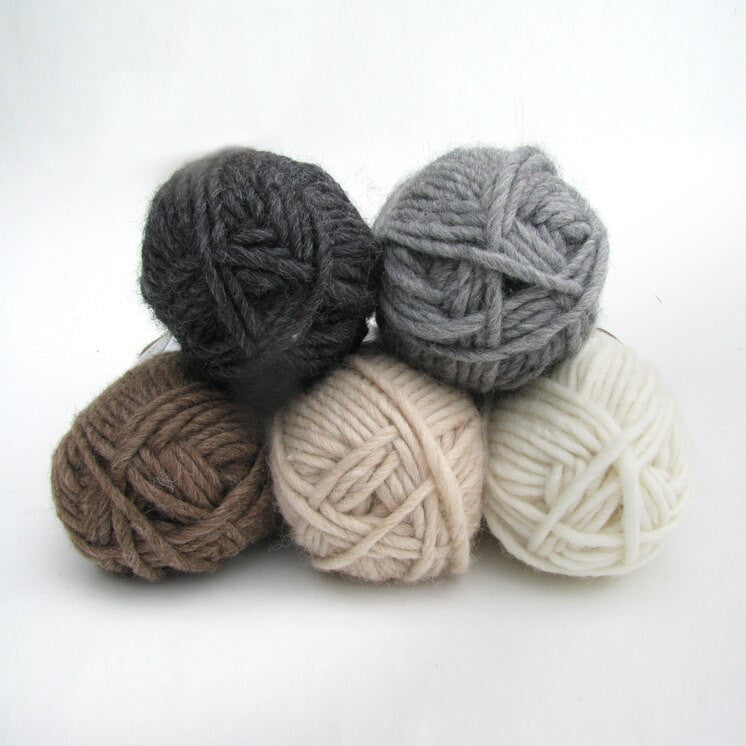 Stack of balls of yarn in different colours.
