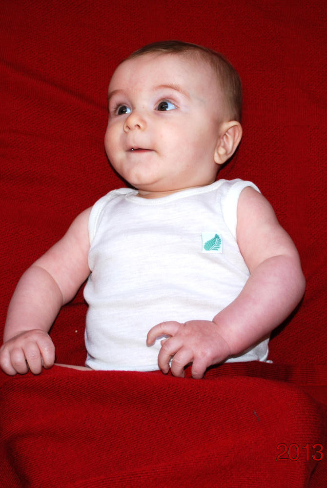 Merino wool baby’s singlet in Winter White colour.