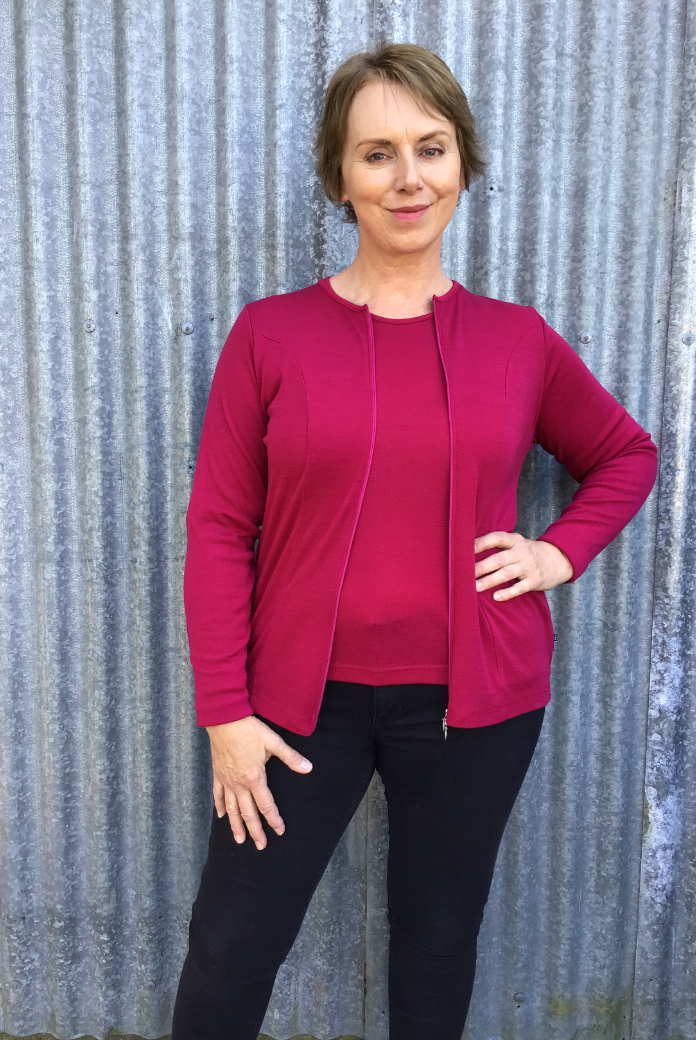 Woman with hand on hip wearing zipped Catherine Cardigan in Cerise