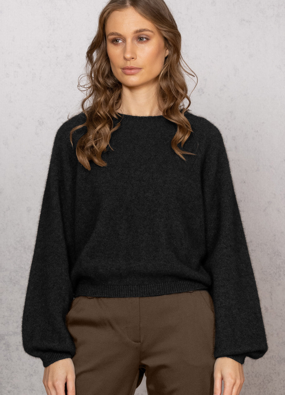 Woman wearing Noble Wilde - Merino & Possum Bellow Sleeve Top in the colour Black.