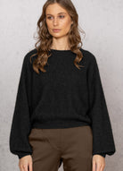 Woman wearing Noble Wilde - Merino & Possum Bellow Sleeve Top in the colour Black.