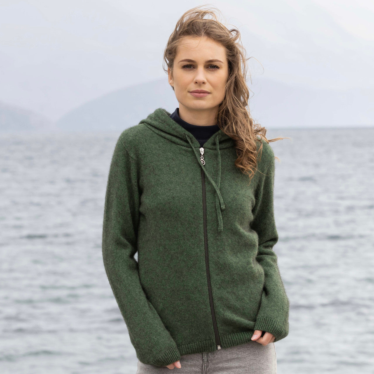 Woman wearing Noble Wilde - Merino and Possum Oulu Hoodie (NW3231) in the colour Jungle.