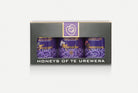 Three pots of honey in purple packaging