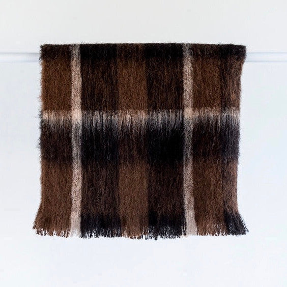 Folded Alpaca fleece throw in Buffalo colour on hanger.