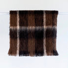 Folded Alpaca fleece throw in Buffalo colour on hanger.