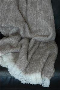 Alpaca fleece throw in Pumice colour draped on couch.