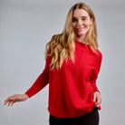 Woman wearing Country Laine - Merino Swing Jumper (CL0075) in the colour Blood Red.