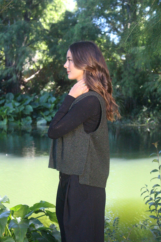 Woman wearing the Lothlorian - Merino & Possum Ride Vest (9650) in the colour Moss.