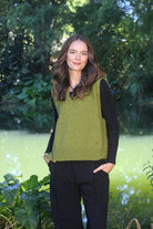 Woman wearing the Lothlorian - Merino & Possum Ride Vest (9650) in the colour Olive.