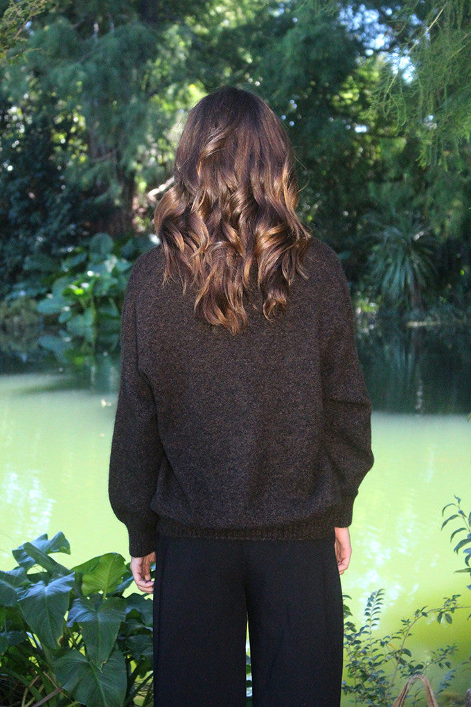 Woman wearing the Lothlorian - Merino & Possum Cavern V Neck Jumper (9789) in the colour Brown Marl.