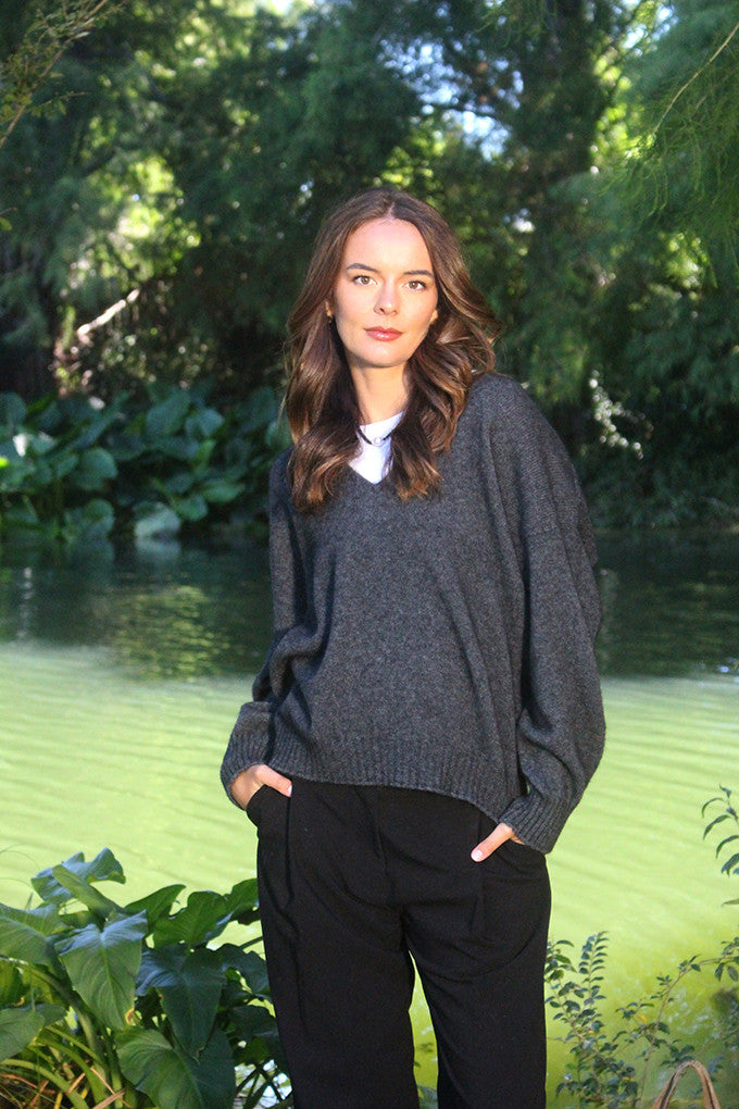 Woman wearing the Lothlorian - Merino & Possum Cavern V Neck Jumper (9789) in the colour Charcoal.