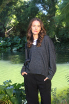 Woman wearing the Lothlorian - Merino & Possum Cavern V Neck Jumper (9789) in the colour Charcoal.