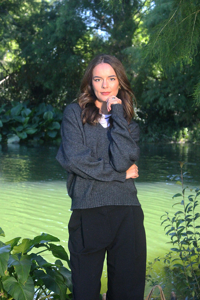 Woman wearing the Lothlorian - Merino & Possum Cavern V Neck Jumper (9789) in the colour Charcoal.