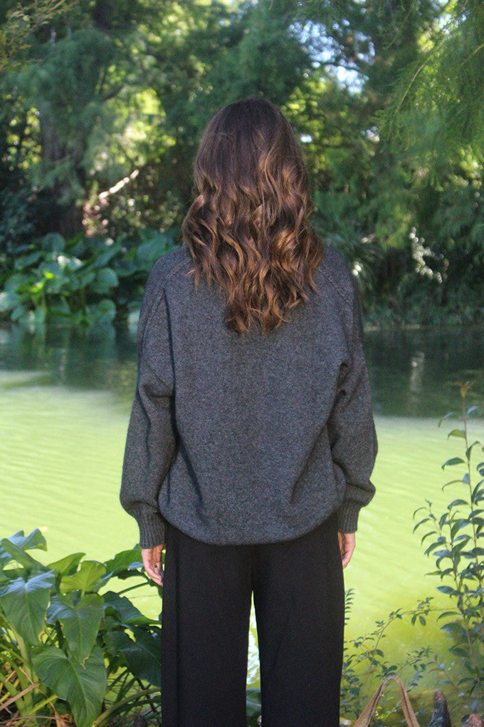Woman wearing the Lothlorian - Merino & Possum Cavern V Neck Jumper (9789) in the colour Charcoal.