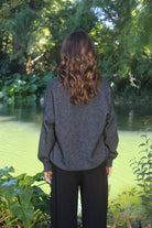 Woman wearing the Lothlorian - Merino & Possum Cavern V Neck Jumper (9789) in the colour Charcoal.