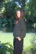 Woman wearing the Lothlorian - Merino & Possum Cavern V Neck Jumper (9789) in the colour Moss.