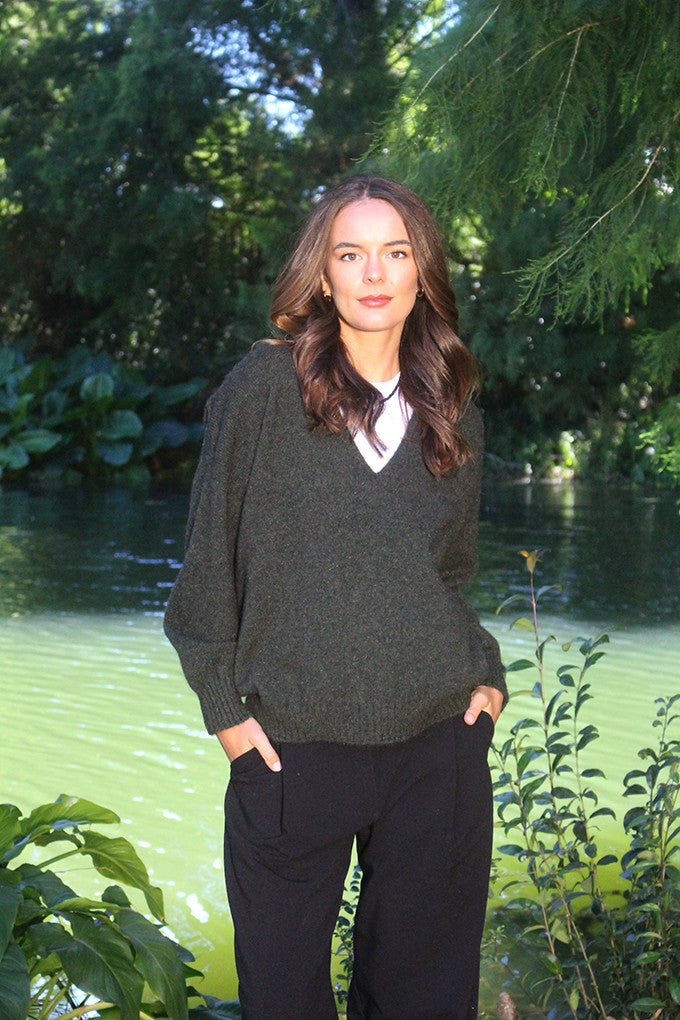 Woman wearing the Lothlorian - Merino & Possum Cavern V Neck Jumper (9789) in the colour Moss.