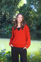 Woman wearing the Lothlorian - Merino & Possum Cavern V Neck Jumper (9789) in the colour Pumpkin.
